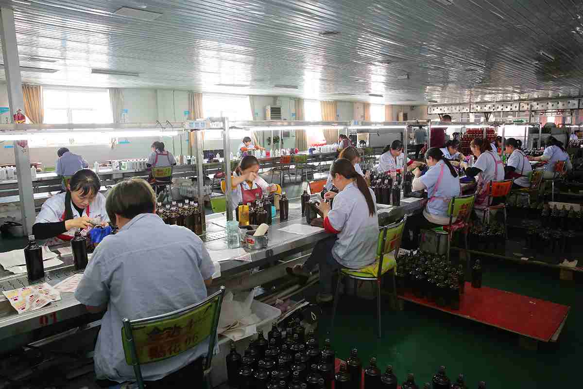 Operators working with bottles at workshop benches